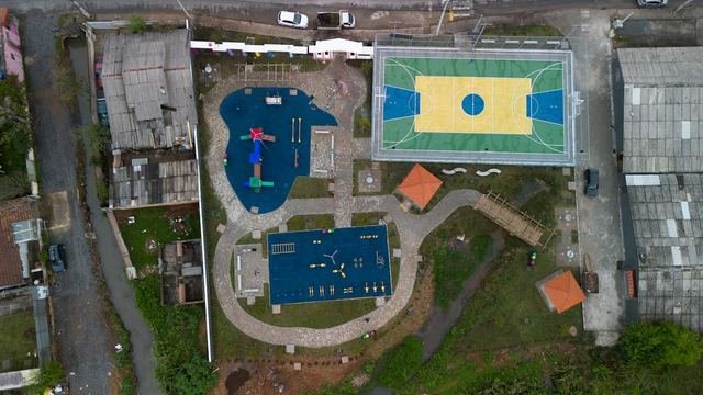 Praça pública em Campo Largo entregue, vista de cima, com quadra, playground e caminhos
